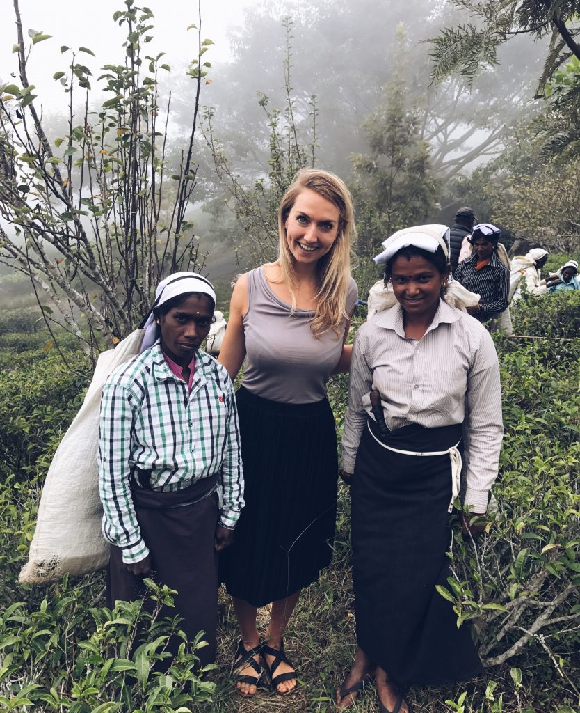 Picture of Claartje Schroder in the tea field in Sri Lanka with tea leaves pickers