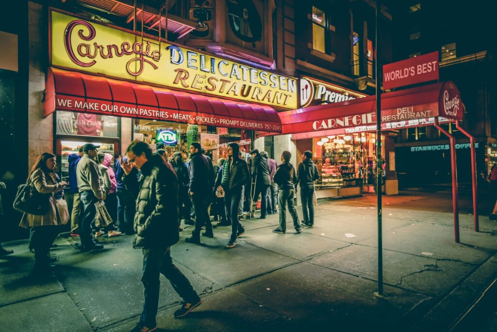 people in front of Carnegic Delicatessen Restaurant